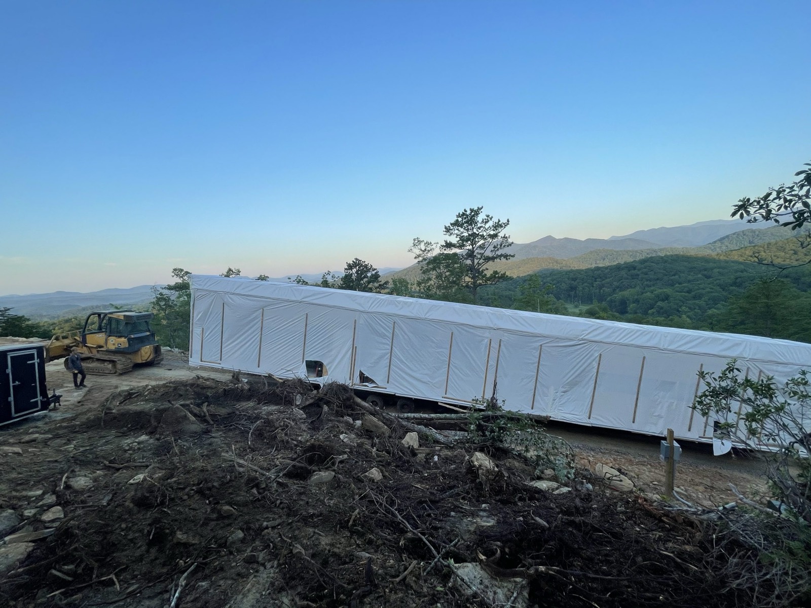 Mountain Movers Grading crew clearing and grading a ridge-top site with a dozer