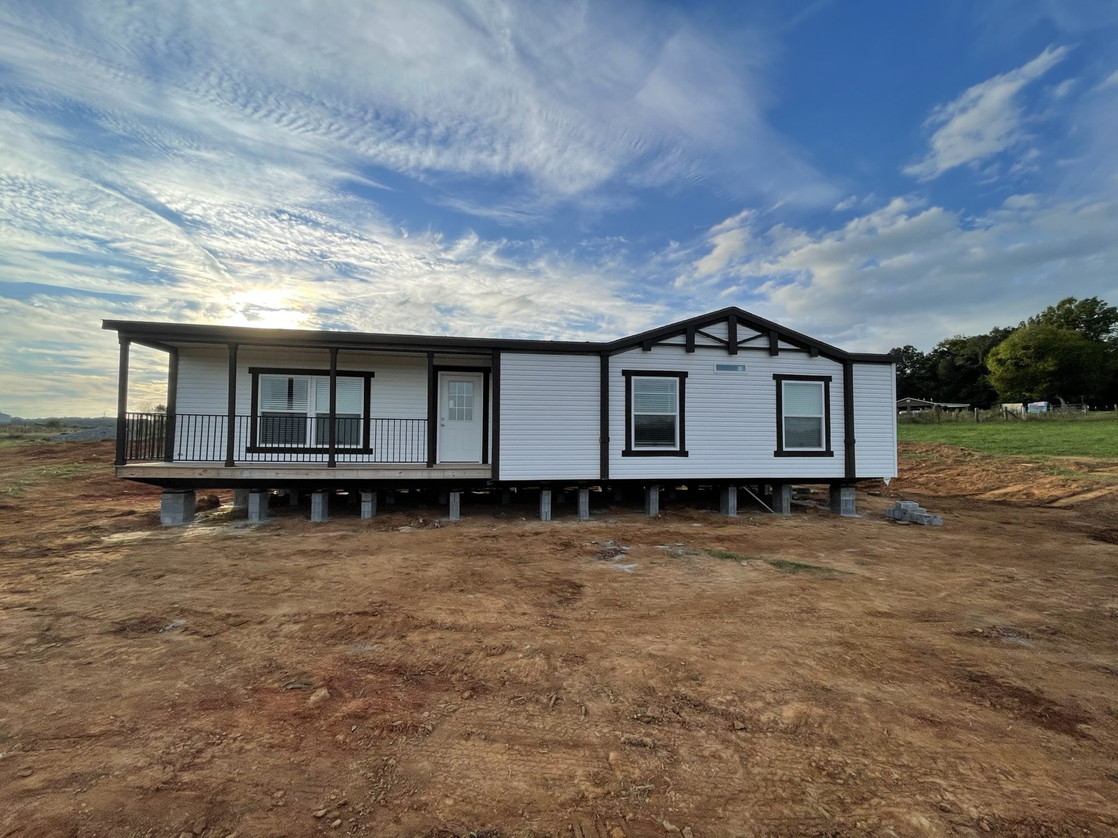 A finished, graded dirt pad with a home set on it